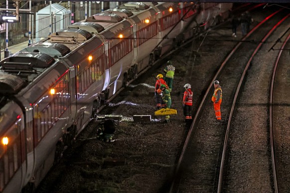 Emergency personnel inspect a train at the Huntingdon, England, train station in Cambridgeshire after people were stabbed Saturday, Nov. 1, 2025. (Chris Radburn/PA via AP)
Britain-Train-Stabbings