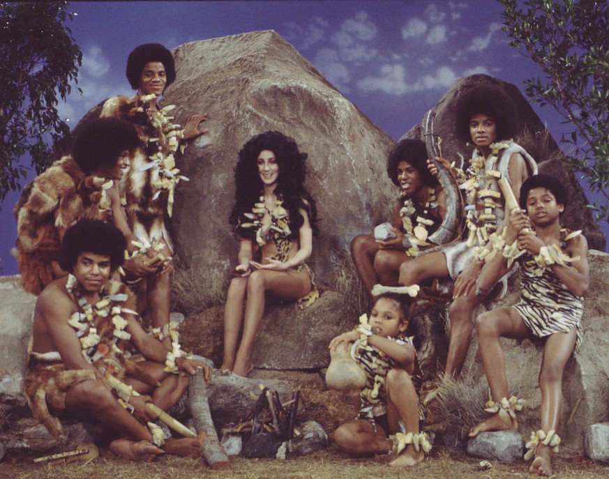 American singer and actress Cher (born Cherilyn Sarkisian LaPiere) (center) and the popular musical group the Jackson 5 in prehistoric garb for a skit on the television variety show &#039;The Sonny &a ...