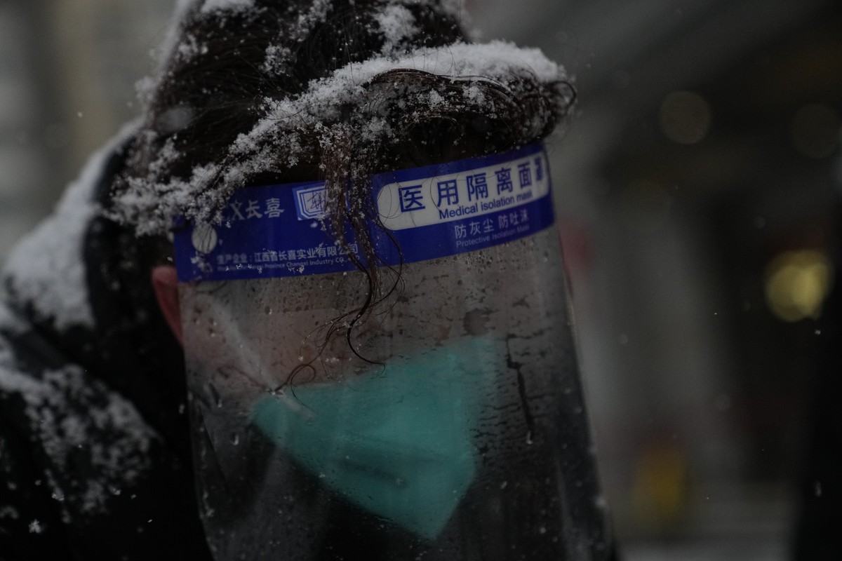 A person's hair is filled with snow during snowfall at the Beijing Winter Olympics Sunday, Feb. 13, 2022, in Beijing. (AP Photo/Brynn Anderson)