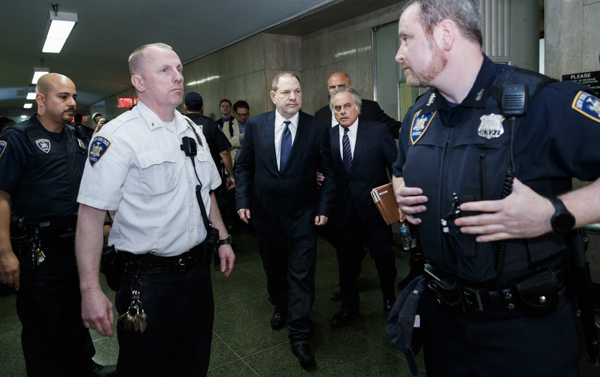 epa06786857 Former movie producer Harvey Weinstein (C) leaves a State Supreme Courtroom after pleading not guilty in his hearing on two counts of rape in State Supreme Court in New York, New York, USA ...