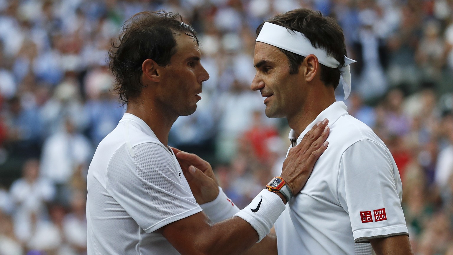 Switzerland's Roger Federer, right, greets Spain's Rafael Nadal after beating him in a Men's singles semifinal match on day eleven of the Wimbledon Tennis Championships in London, Friday, July 12, 201 ...