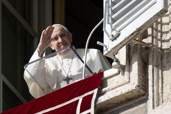 epa09569636 A handout picture provided by the Vatican Media shows Pope Francis recites the Angelus prayer from the window of his study overlooking Saint Peter&#039;s Square, Vatican City, 07 November  ...