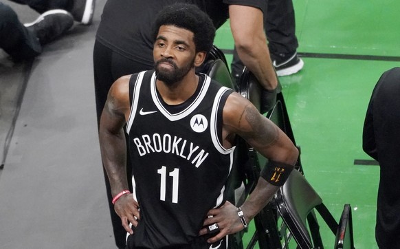 FILE - Brooklyn Nets guard Kyrie Irving looks up at the fans at TD Garden after they defeated the Boston Celtics in Game 4 during an NBA basketball first-round playoff series in Boston, in this Sunday ...