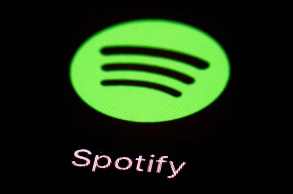 FILE- This March 20, 2018, file photo shows the Spotify app on an iPad in Baltimore. Spotify is backpedaling on its recently announced anti-hate policy after some music industry players criticized it. ...