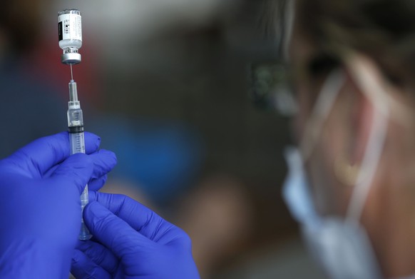 FILE - In this June 22, 2021, file photo, nurse Jody Berry draws a syringe full of the Johnson &amp; Johnson COVID-19 vaccine at a clinic at Mother&#039;s Brewing Company in Springfield, Mo. New York  ...