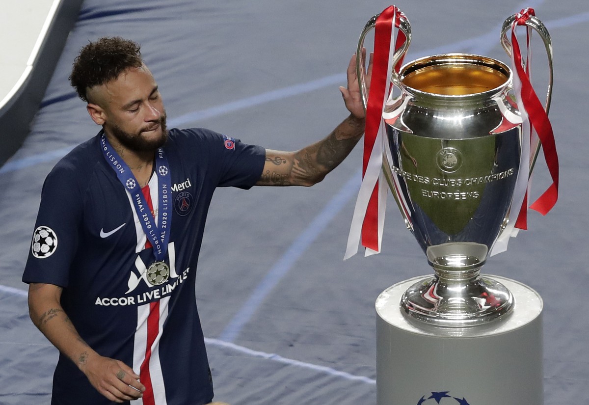 PSG's Neymar touches the trophy after the Champions League final soccer match between Paris Saint-Germain and Bayern Munich at the Luz stadium in Lisbon, Portugal, Sunday, Aug. 23, 2020. (AP Phot ...
