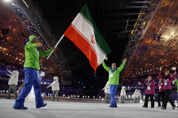 FILE - Hossein Saveh Shemshaki of Iran carries the national flag as he leads the team during the opening ceremony of the 2014 Winter Olympics in Sochi, Russia, on Feb. 7, 2014. IranÄôs only male athl ...