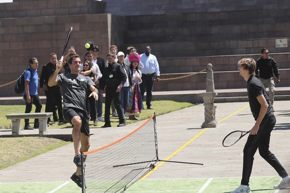 Swiss Roger Federer, left, and German Alexander Zverev play for few minutes after a press conference at Mitad del Mundo on the equator in Quito, Ecuador. Sunday, Nov. 24, 2019. Federer and Zverev will ...