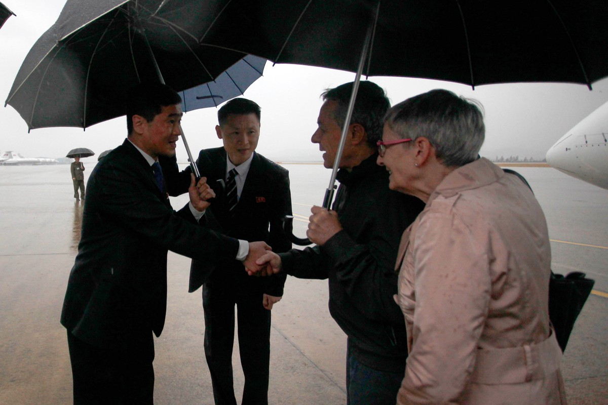 Swiss Foreign Minister Ignazio Cassis, center right, is greeted by officials of North Korea's ministry of foreign affairs on the arrival at Pyongyang International Airport in Pyongyang, North Kor ...