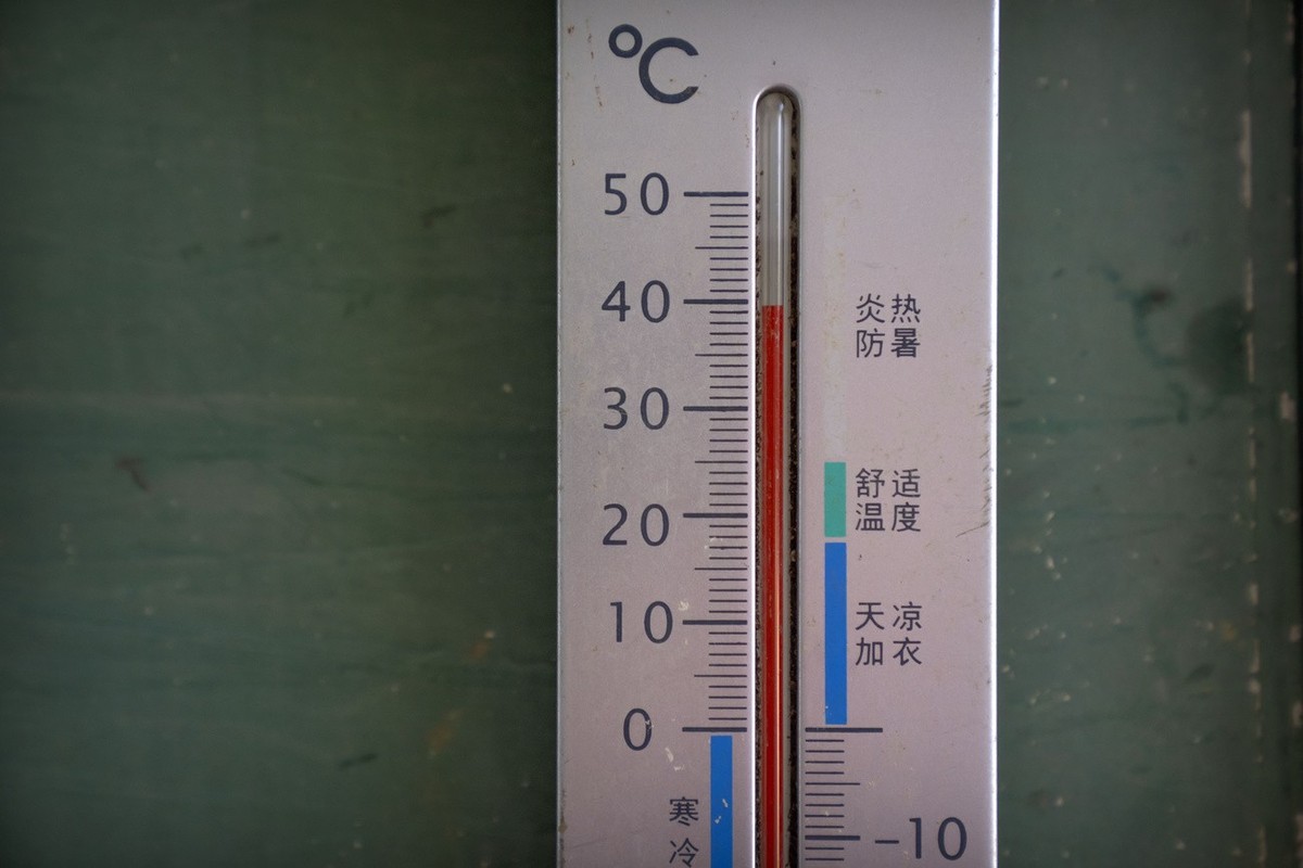 A thermometer shows a temperature of nearly 40 degrees Celsius (104 F) in the shade before midday in Longquan village in southwestern China's Chongqing Municipality, Saturday, Aug. 20, 2022. Drou ...