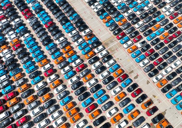epa11217305 An aerial drone photo shows vehicles for export parking at Jiangyin terminal of Fuzhou Port in Fuzhou, southeast China, 12 March 2024. Four thousand vehicles produced by the passenger car  ...