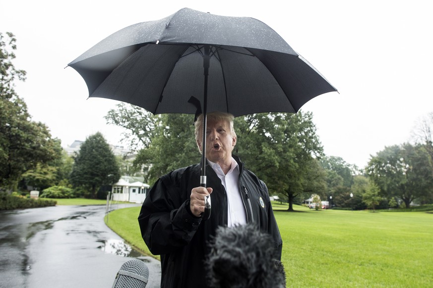 epa07095112 US President Donald J. Trump delivers remarks to members of the news media at the South Lawn of the White House before departing by Marine One with First Lady Melania Trump, in Washington, ...