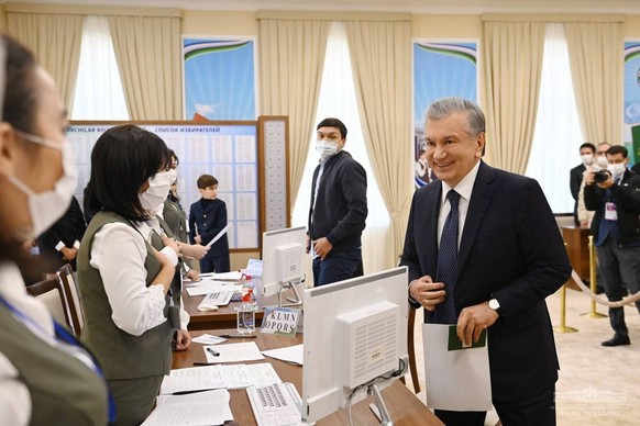 epa09542774 A handout photo made available by Uzbekistan President press service shows Uzbekistan President Shavkat Mirziyoyev attends the Uzbek presidential elections on the polling station in Tashke ...