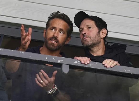 Wrexham co-owner Ryan Reynolds, left, and Paul Rudd in the stands during the National League soccer match between Wrexham and Boreham Wood at The Racecourse Ground, in Wrexham, Wales, Saturday April 2 ...