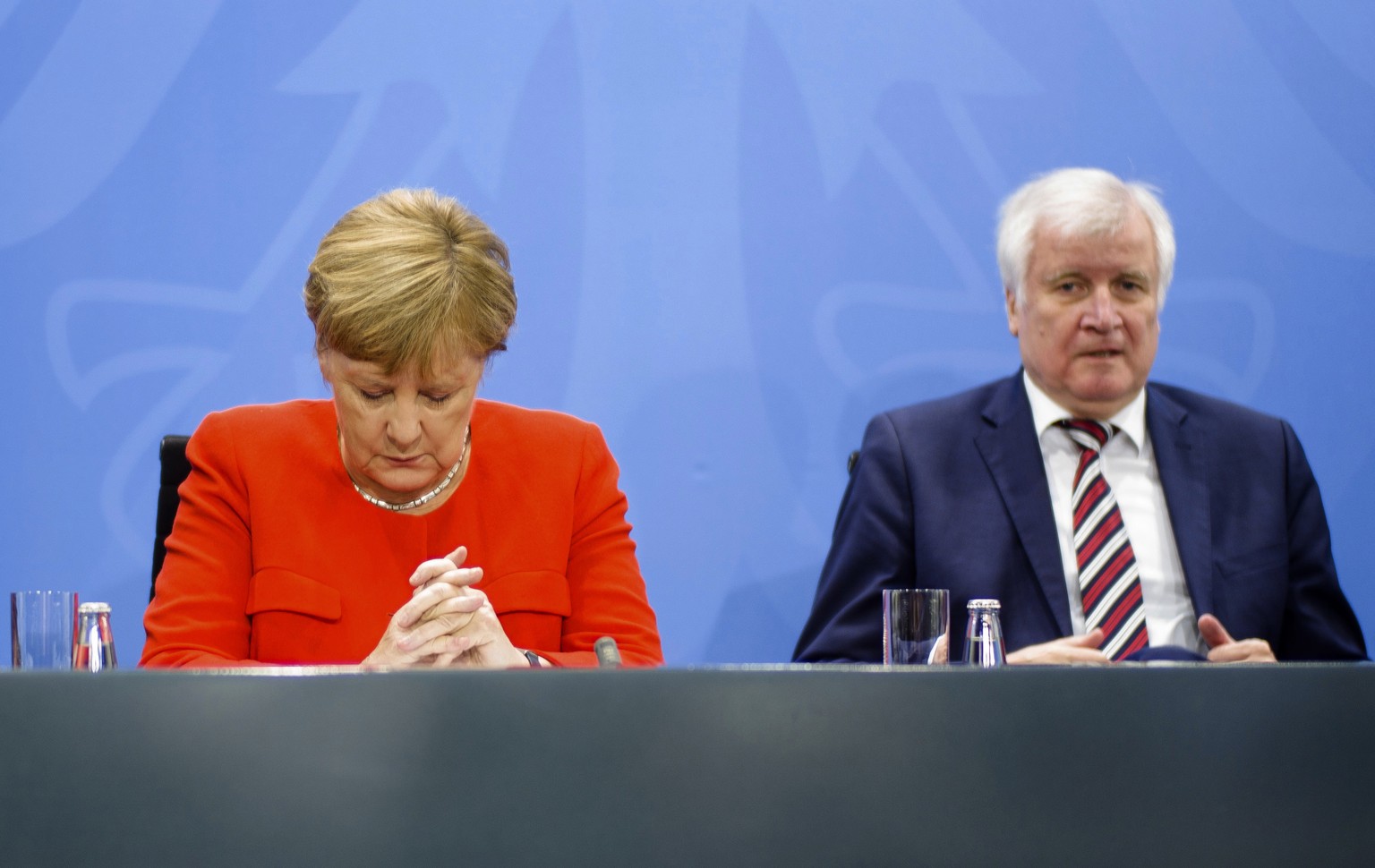 FILE - In this Sept. 21, 2018 file photo German Chancellor Angela Merkel, left, and Interior Minister Horst Seehofer, right, listen to Vice Chancellor and German Finance Minister Olaf Scholz during a  ...