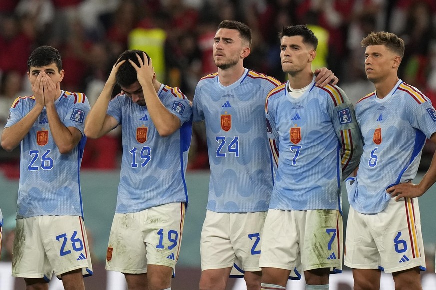 Spain&#039;s Pedri, from left, Carlos Soler, Aymeric Laporte, Alvaro Morata and Marcos Llorente react after the penalty shootout at the World Cup round of 16 soccer match between Morocco and Spain, at ...