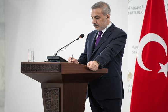 epa12608776 Turkish Foreign Minister Hakan Fidan attends a joint press conference with his Syrian counterpart in Damascus, Syria, 22 December 2025. A Turkish delegation, including the foreign minister ...