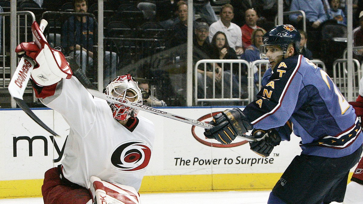 Atlanta Thrashers' Patrik Stefan, right, of the Czech Republic, reaches for the puck over Carolina Hurricanes goalie Martin Gerber, of Switzerland, in front of the goal during the first period of ...