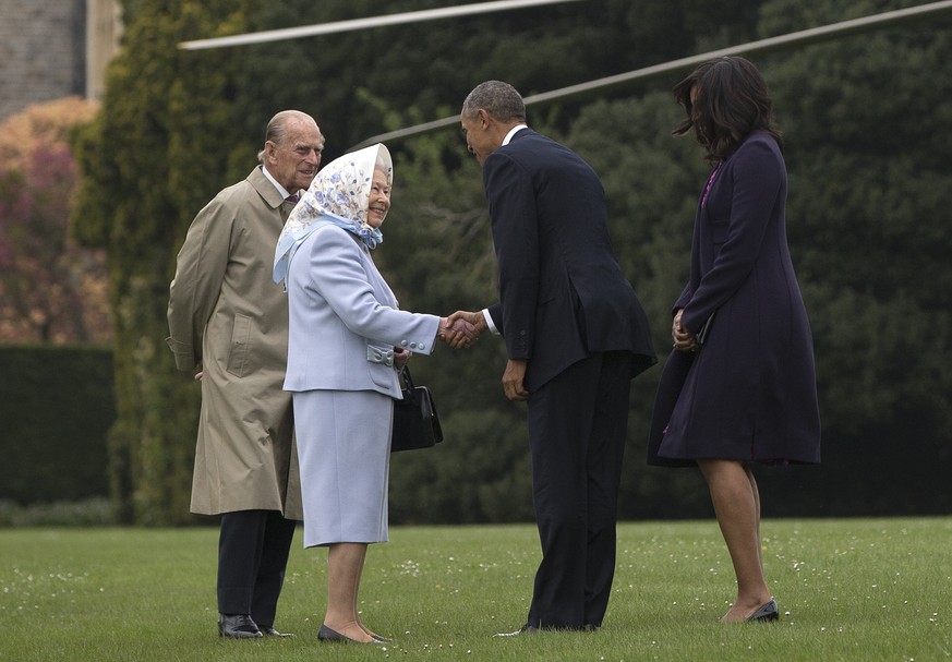 President Barack Obama and first lady Michelle Obama are greeted by Queen Elizabeth II and Prince Philip as they arrive on Marine One at Windsor Castle in Windsor, England, Friday, April 22, 2016. Oba ...