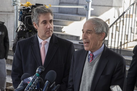 epa10525044 Michael Cohen (L), Donald Trump?s former lawyer, and his attorney Lanny Davis (R), speak to the press after completing his testimony to a Manhattan grand jury in New York, New York, USA, 1 ...