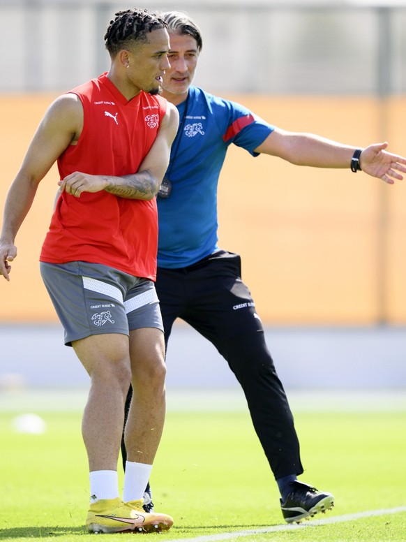 Switzerland's forward Noah Okafor, left, and Switzerland's head coach Murat Yakin, right, attend a open training session of Swiss national soccer team in preparation for the FIFA World Cup Q ...