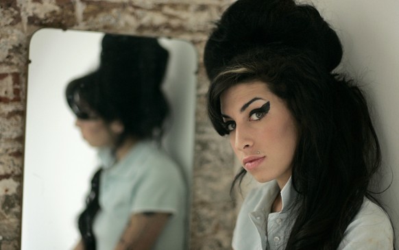 FILE - In this Feb. 16, 2007 file photo, British singer Amy Winehouse poses for photographs after being interviewed by The Associated Press at a studio in north London. Friday, July 23, 2021 marks the ...