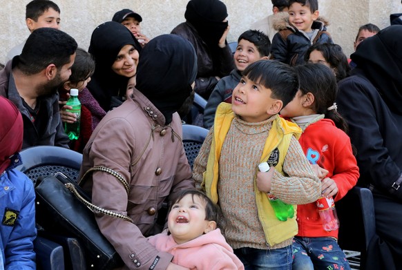 epa06600784 Syrian people from eastern Ghouta wait near the safe corridor at al-Wafideen camp before evacuation, in the countryside of Damascus, Syria, 13 March 2018. According to Syrian official medi ...