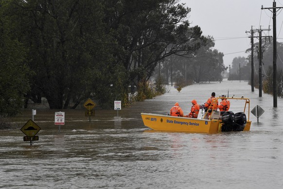 A New South Wales State Emergency Service (SES) crew is seen in a rescue boat as roads are submerged under floodwater from the swollen Hawkesbury River in Windsor, northwest of Sydney, Monday, July 4, ...