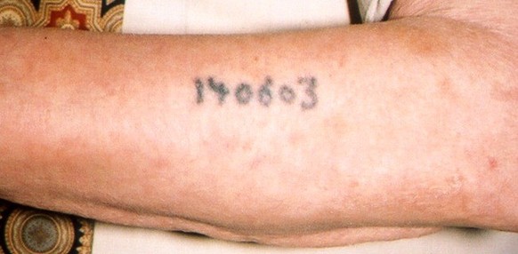 Auschwitz survivor displays tattoo detail