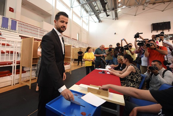 epa10685416 President of Montenegro Jakov Milatovic casts his vote in the parliamentary elections in Podgorica, Montenegro, June 11, 2023. Montenegro votes in a snap parliamentary election that ...