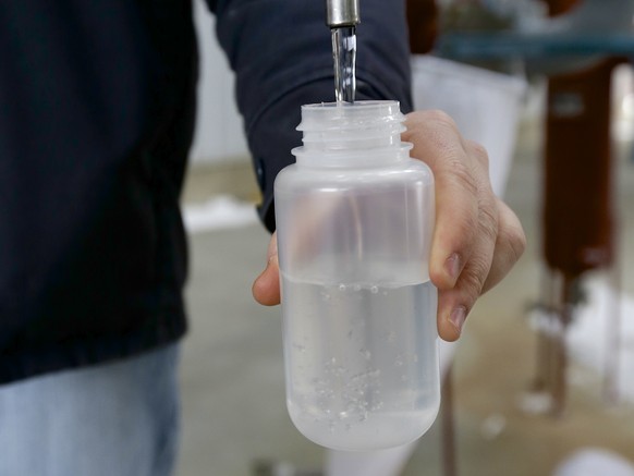 In this photo from Jan. 6, 2015, Ryan Brock fills a sample bottle with ethanol produced at the Green Plains ethanol plant in Shenandoah, Iowa. Oil prices may have dipped below $50 a barrel for the fir ...