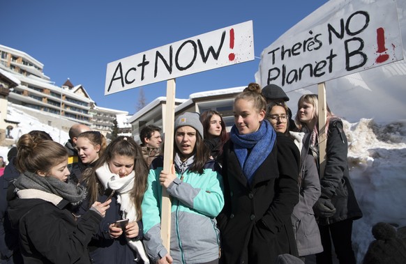Students demonstrate for the School Strike for (4) Climate in front of the entrance of Congress Center the last day of the 49th Annual Meeting of the World Economic Forum, WEF, in Davos, Switzerland,  ...