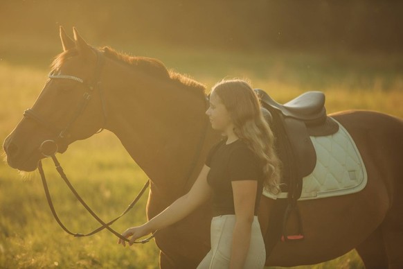 Girl with horse walking in meadow on sunny day model released, Symbolfoto property released, VSNF02465