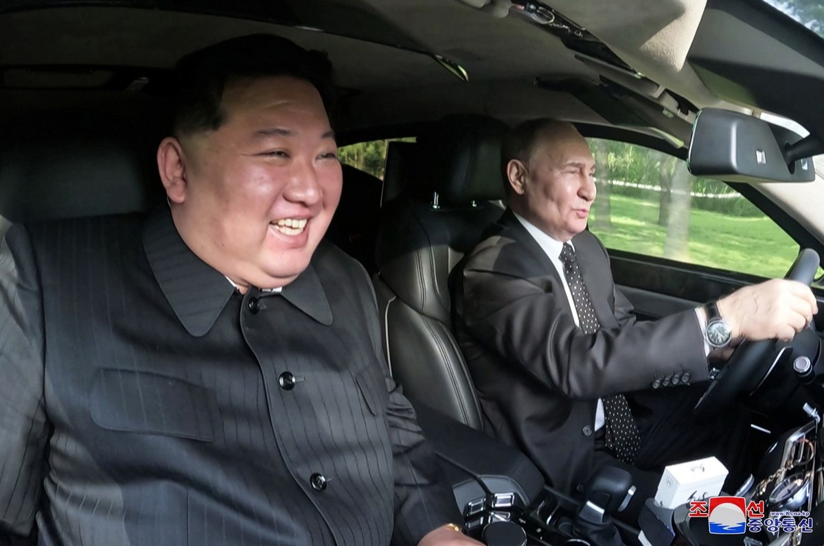 A photo released by the official North Korean Central News Agency (KCNA) on 20 June 2024, shows Russian President Vladimir Putin driving North Korean leader Kim Jong Un in an Aurus limousine in Pyongy ...