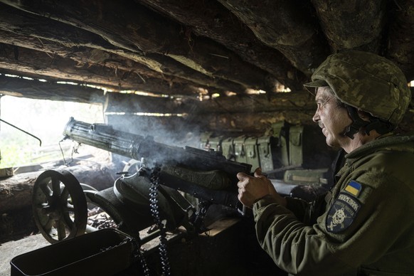 FILE - A Ukrainian serviceman of 28th brigade shoots a Maxim gun towards Russian positions at the frontline in Donetsk region, Ukraine, Wednesday, June 21, 2023. Ukrainian forces are making steady pro ...