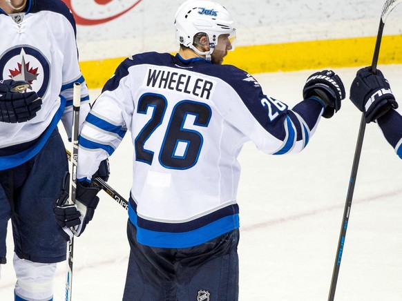 Jan 15, 2016; Saint Paul, MN, USA; Winnipeg Jets goalie Connor Hellebuyck (30), defenseman Tyler Myers (57), forward Blake Wheeler (26) and forward Mathieu Perreault (85) celebrate following the game  ...