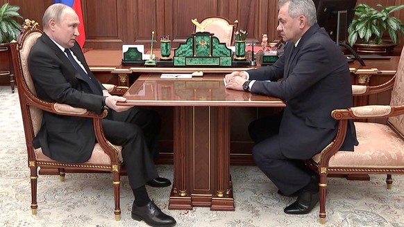 In this photo released by the Russian Presidential Press Service, Russian President Vladimir Putin, left, and Russian Defense Minister Sergei Shoigu look at each other during their meeting in the Krem ...