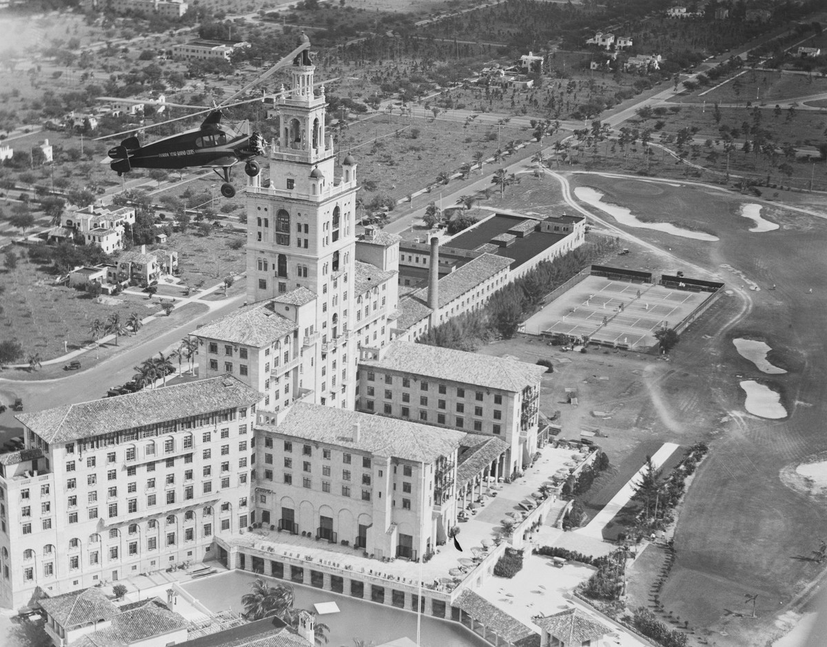 (Original Caption) Aerial Taxi Service. Hovering high above the Miami Biltmore Hotel in Miami, Florida, the world's largest autogiro, also the first such ship of cabin design, makes its first fli ...
