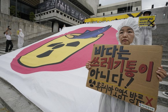 Environmental activists stage a rally against Japanese government&#039;s plan to release treated radioactive water from Fukushima nuclear power plant, in Seoul, South Korea, Monday, Aug. 7, 2023. The  ...