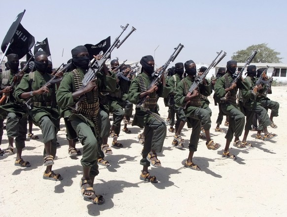 FILE - Hundreds of newly trained al-Shabab fighters perform military exercises in the Lafofe area some 18 km south of Mogadishu, in Somalia on Feb. 17, 2011. The al-Qaida-linked al-Shabab is projectin ...