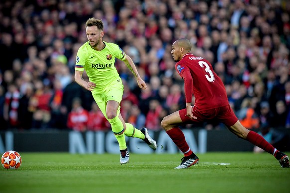 epa07554501 Barcelona's Ivan Rakitic (L) in action against Liverpool's Fabinho (R) during the UEFA Champions League semi final second leg soccer match between Liverpool FC and FC Barcelona at Anfield  ...
