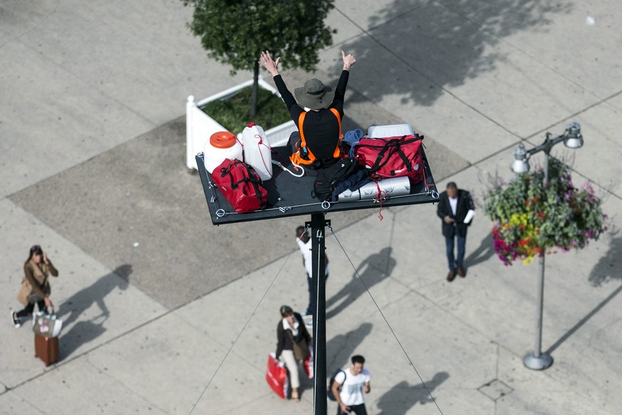 epa05556964 French artist Abraham Poincheval sits atop a 20-meter-high platform in front of the Gare de Lyon in Paris, France, 26 September 2016. Poincheval plans to live on the platform for six days  ...