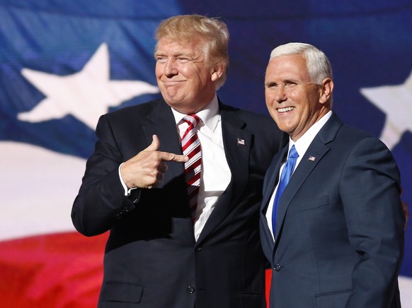 epa08939628 (FILE) Republican Presidential nominee Donald J. Trump (L) embraces Indiana Governor and Republican Vice Presidential nominee Mike Pence (R) during the third day of the 2016 Republican Nat ...