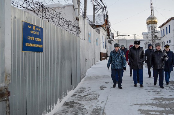 In this photo released by Human rights ombudsman of Yamalo-Nenets Autonomous District on Friday, Dec. 15, 2023, a group of officers walk inside a prison colony in the town of Kharp, in the Yamalo-Nene ...
