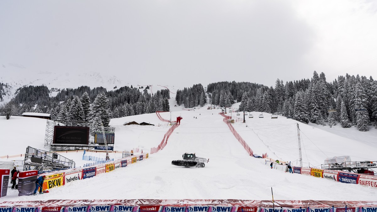 epa09077497 A snowcat removes fresh snow in the finish area before a downhill training race at the FIS Alpine Skiing World Cup finals, in Lenzerheide, Switzerland, 16 March 2021. EPA/JEAN-CHRISTOPH BO ...