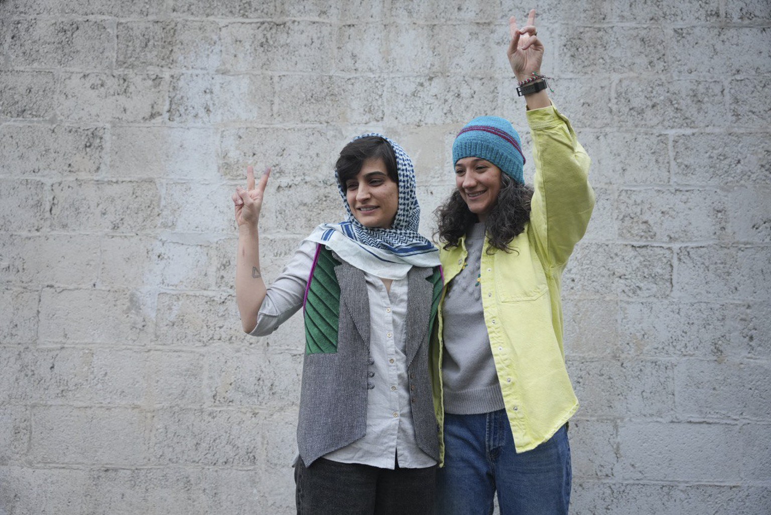 Iranian journalists Niloufar Hamedi, right, and Elaheh Mohammadi, flash the victory sign after being released from prison, in Tehran, Iran, Sunday, Jan. 14, 2024. The two who were serving long prison  ...