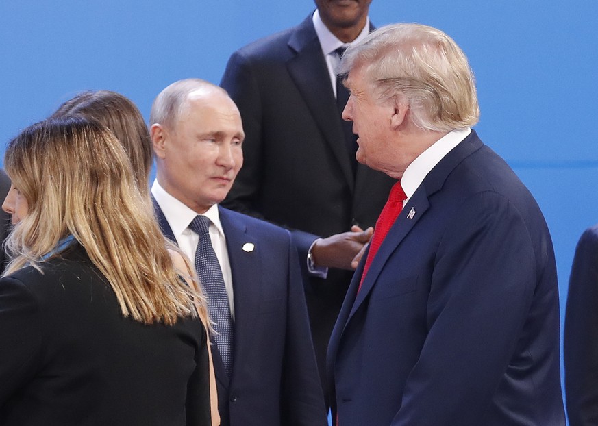 FILE - In this Nov. 30, 2018, file photo, President Donald Trump, right, walk past Russia&#039;s President Vladimir Putin, left, as they gather for the group photo at the start of the G20 summit in Bu ...