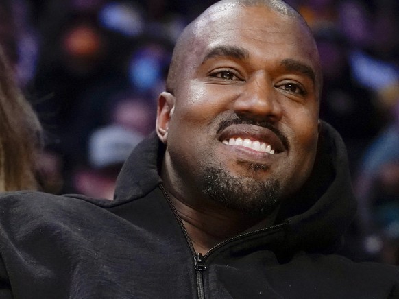 FILE - Kanye West watches the first half of an NBA basketball game between the Washington Wizards and the Los Angeles Lakers in Los Angeles, on March 11, 2022 A completed documentary about the rapper  ...