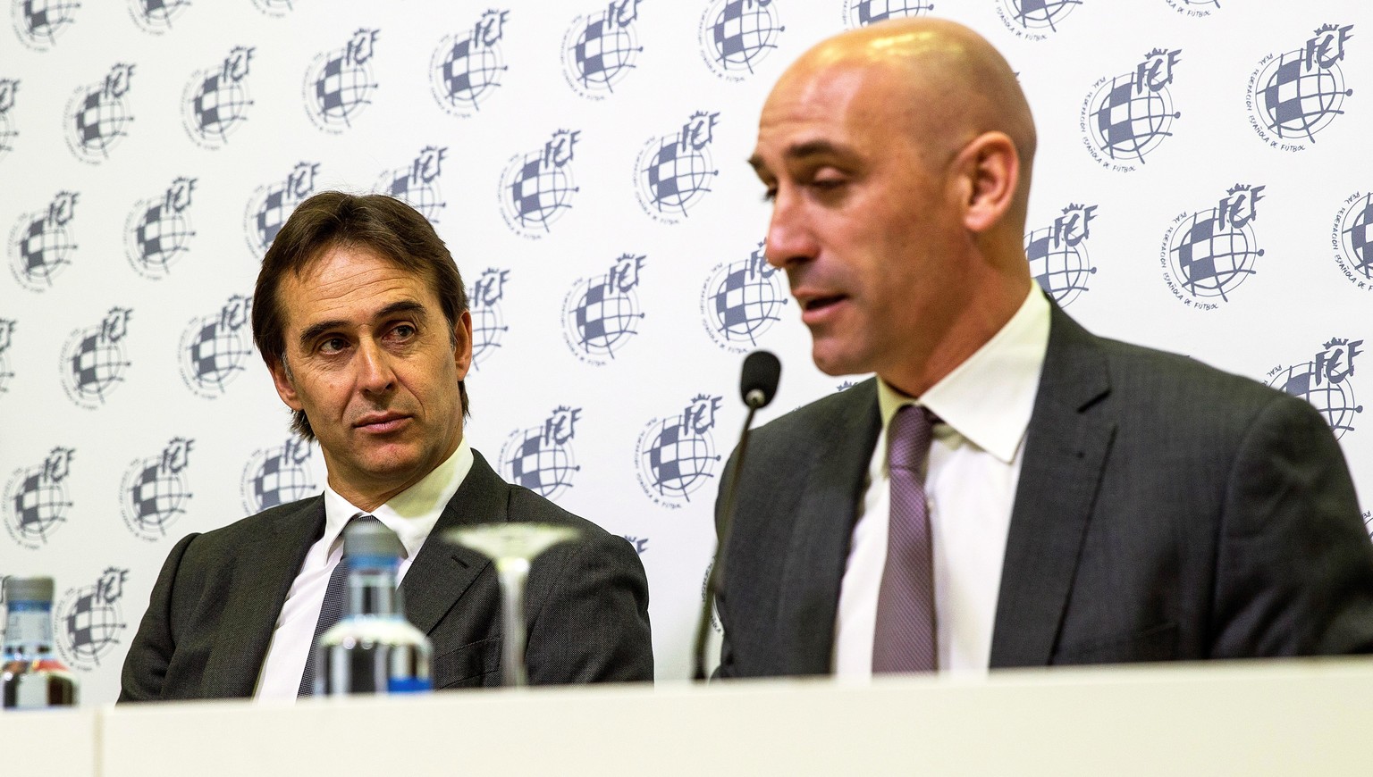 epa06755450 Spanish national soccer team head coach Julen Lopetegui (L) listens to Luis Rubiales (R), new president of the Royal Spanish Football Federation (RFEF), during a press conference after ext ...