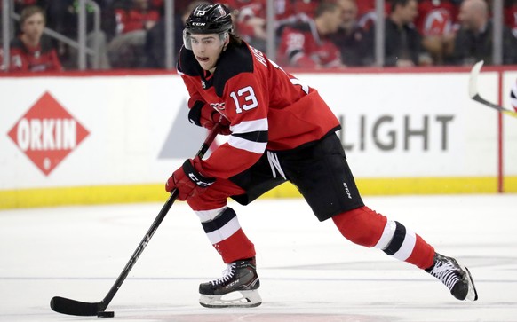 FILE - In this April 18, 2018, file photo, New Jersey Devils center Nico Hischier, of Switzerland, skates against the Tampa Bay Lightning during the second period of Game 4 of an NHL first-round hocke ...